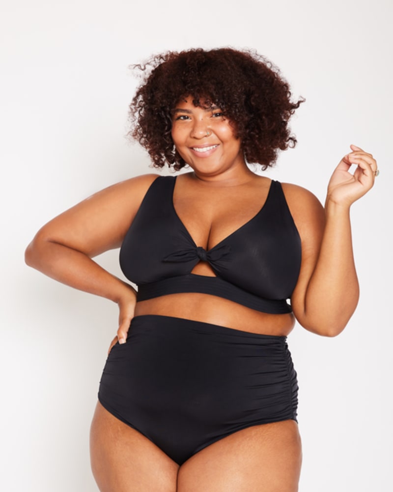 Front of a model wearing a size 1 Dottie Tie Bikini Top in Black by Wild Isles Swim. | dia_product_style_image_id:251687